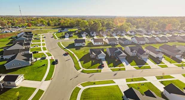 GettyImages-1893788382 Aerial view of suburban neighborhood and streets.